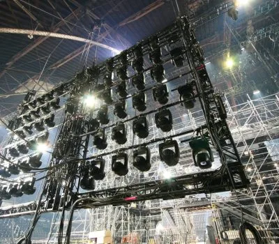 Lighting grid inside theater , looking up at back of lighting grid and rigging during a performance.