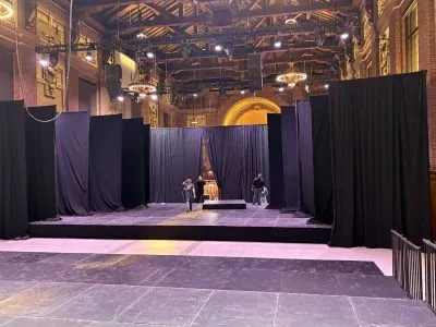 Rows of Pipe and Drape hang on either side of a room