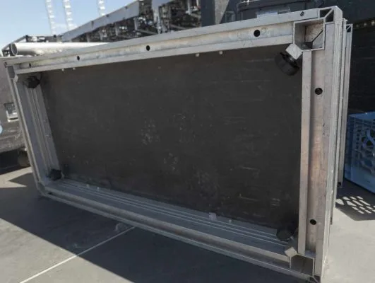 A UNI-DEC vertical on its long end on a stage outdoors. View is looking at the underside of the 4x8 foot unidec