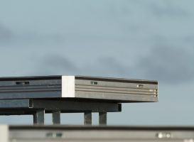 a single uni-dec sitting on a base on top of a stage. blue sky behind it.