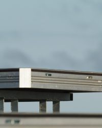 a single uni-dec sitting on a base on top of a stage. blue sky behind it.