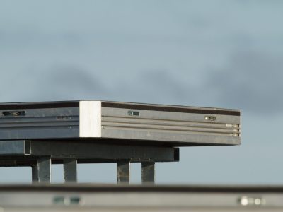 a single uni-dec sitting on a base on top of a stage. blue sky behind it.